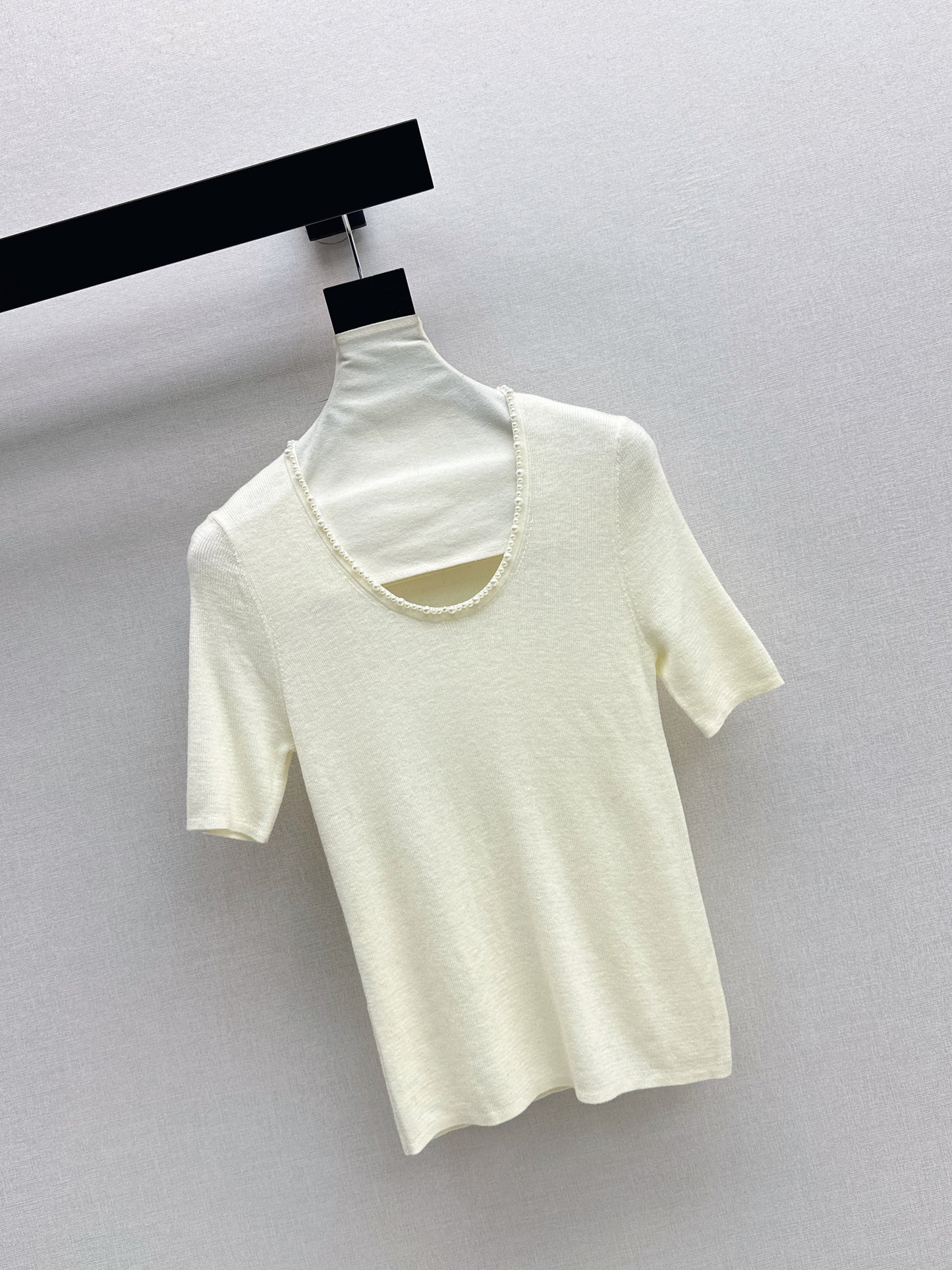 Pearl embellishments on a short-sleeved top