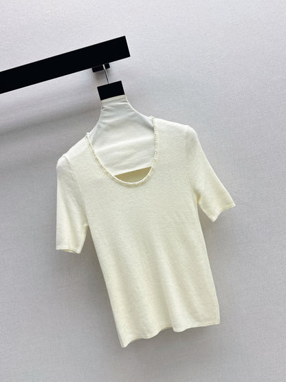 Pearl embellishments on a short-sleeved top
