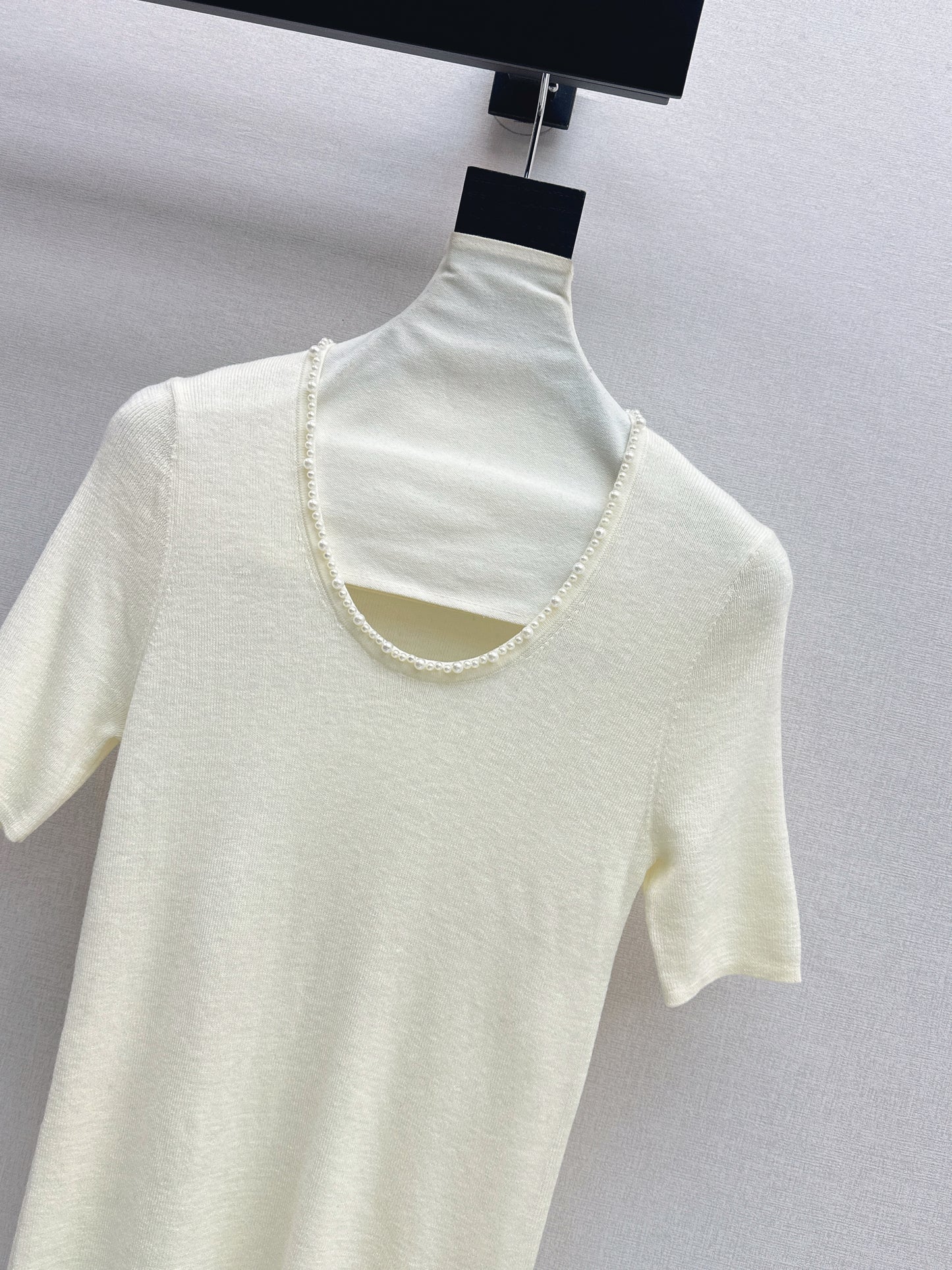 Pearl embellishments on a short-sleeved top