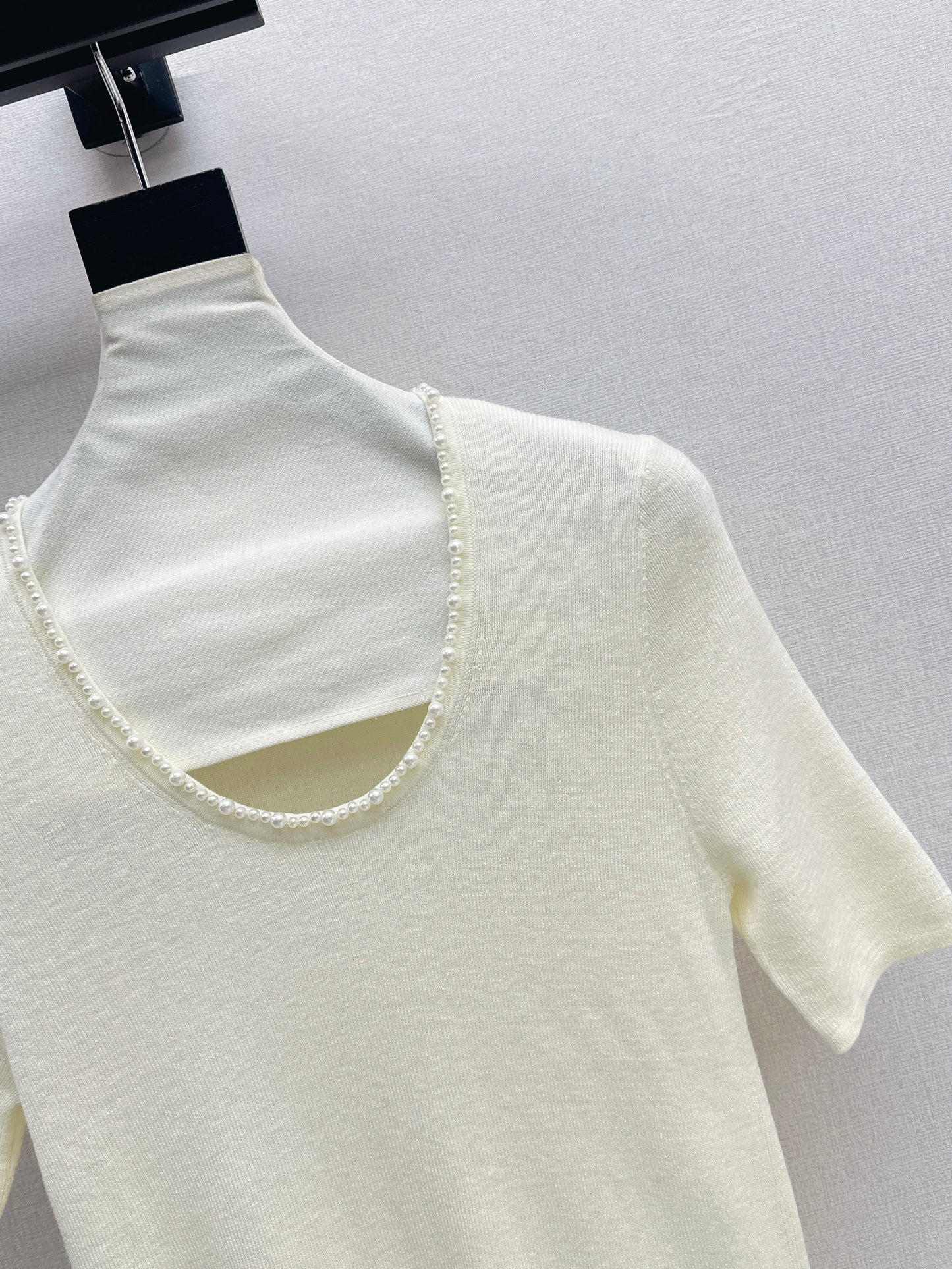 Pearl embellishments on a short-sleeved top