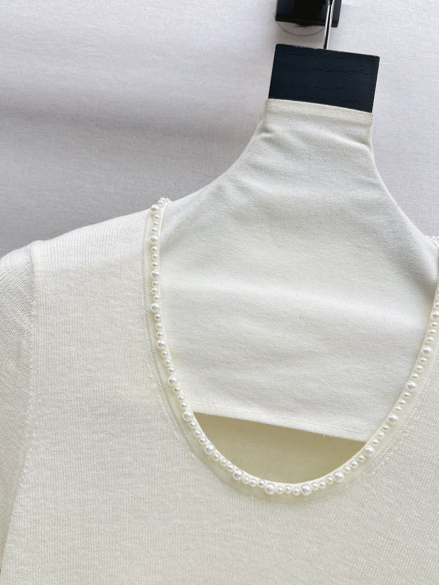 Pearl embellishments on a short-sleeved top