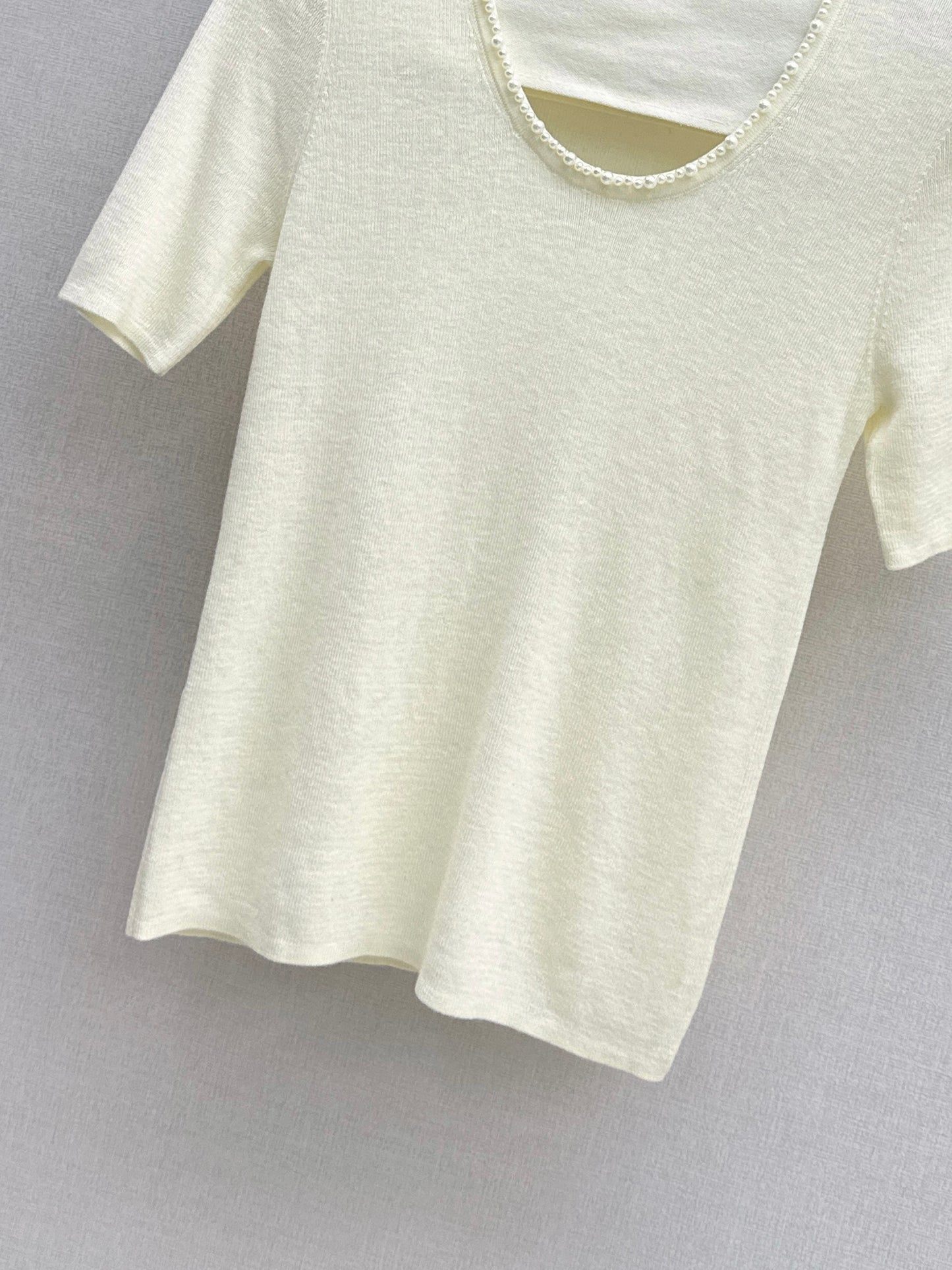 Pearl embellishments on a short-sleeved top