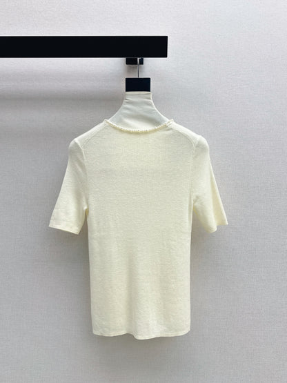 Pearl embellishments on a short-sleeved top