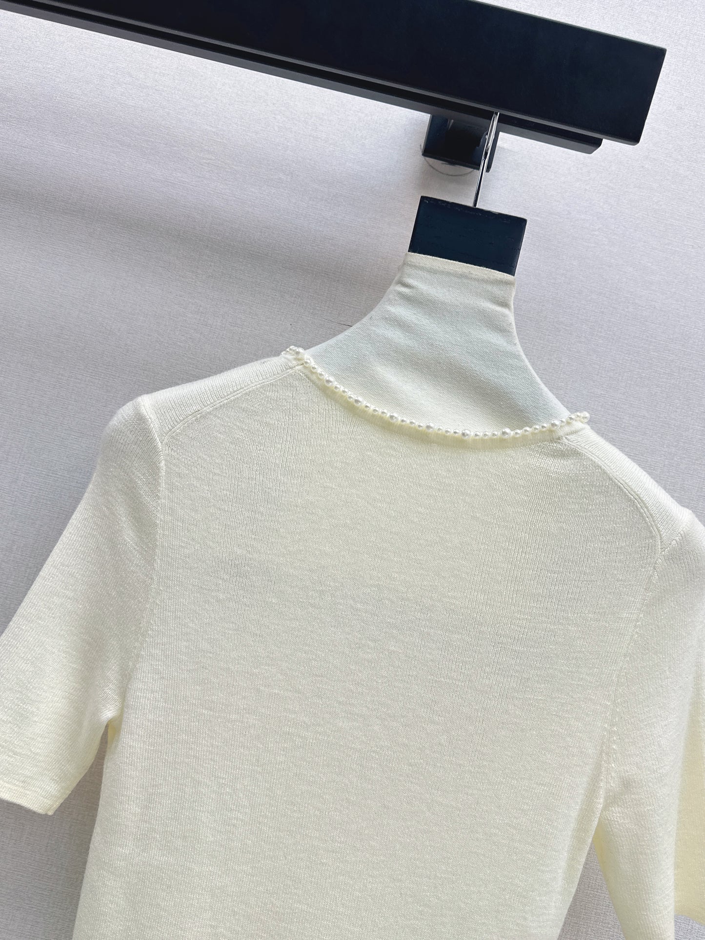 Pearl embellishments on a short-sleeved top