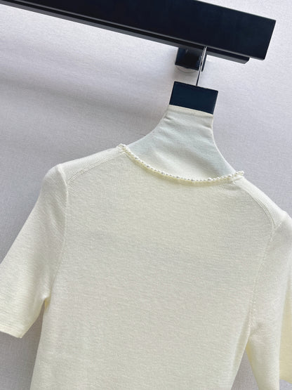Pearl embellishments on a short-sleeved top