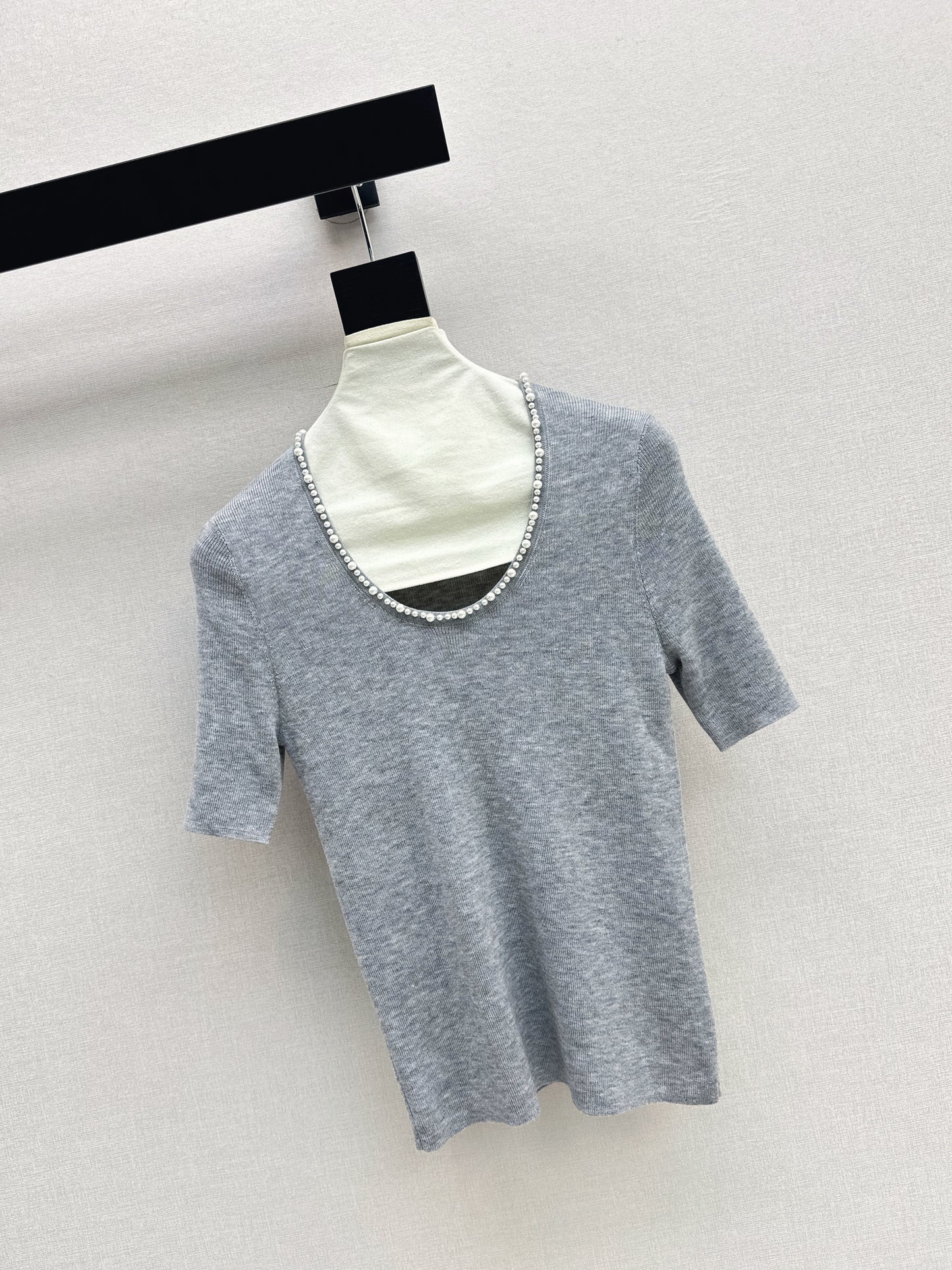 Pearl embellishments on a short-sleeved top