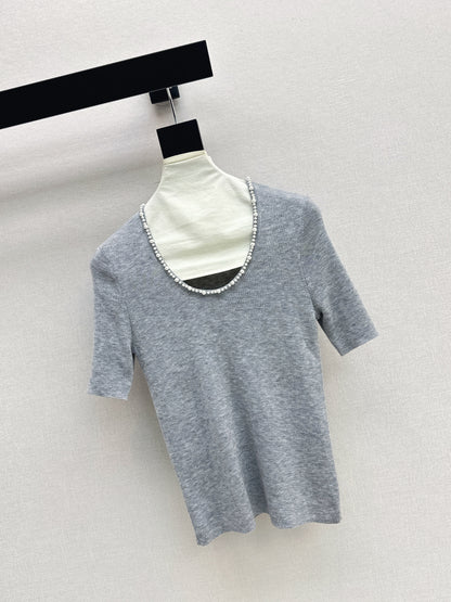 Pearl embellishments on a short-sleeved top