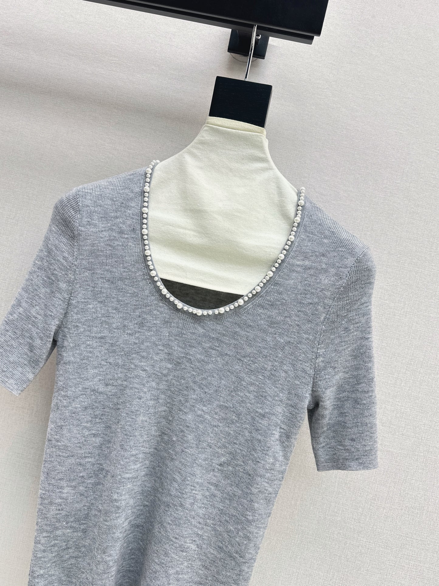 Pearl embellishments on a short-sleeved top