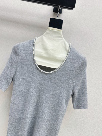 Pearl embellishments on a short-sleeved top