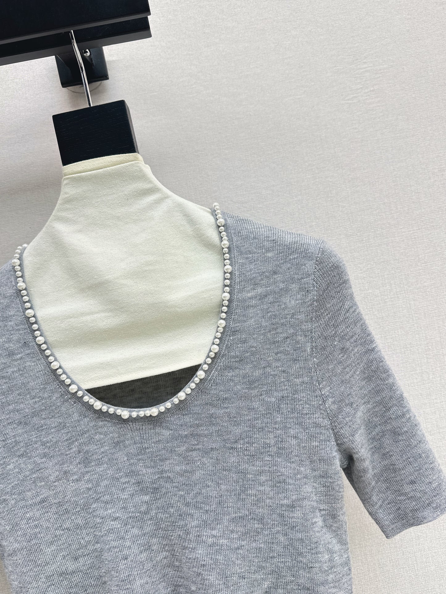 Pearl embellishments on a short-sleeved top
