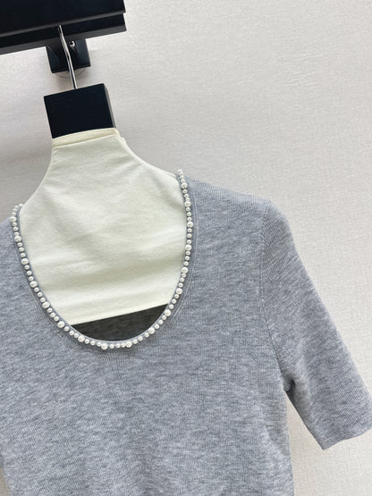Pearl embellishments on a short-sleeved top