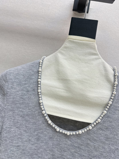 Pearl embellishments on a short-sleeved top