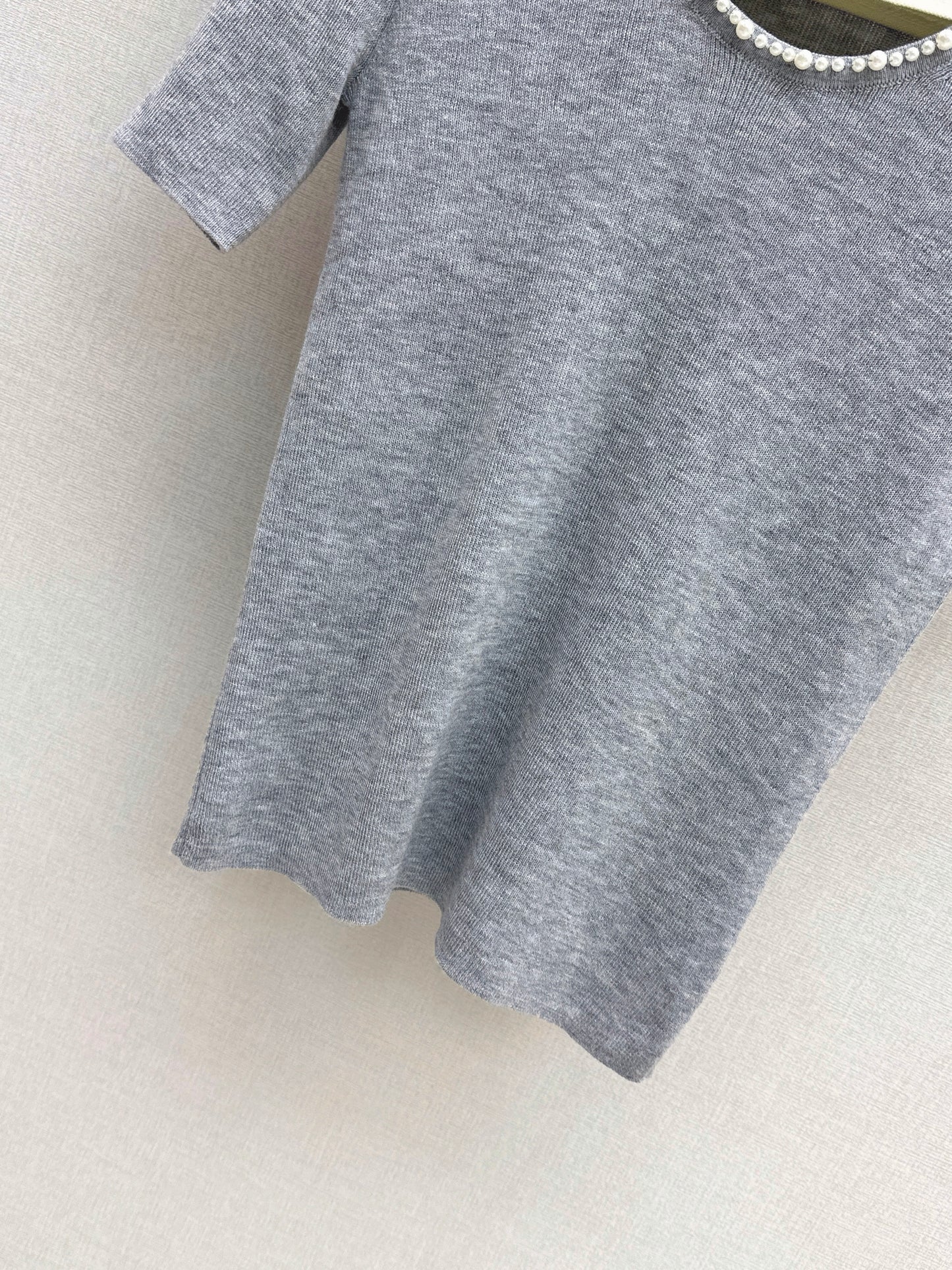 Pearl embellishments on a short-sleeved top