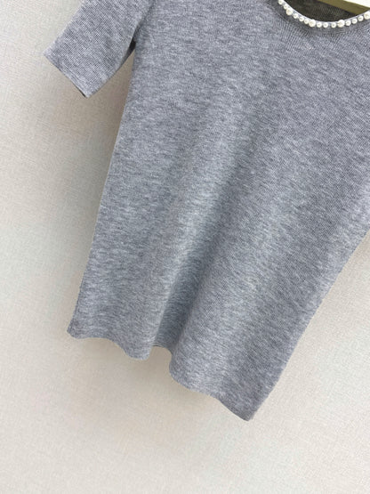 Pearl embellishments on a short-sleeved top