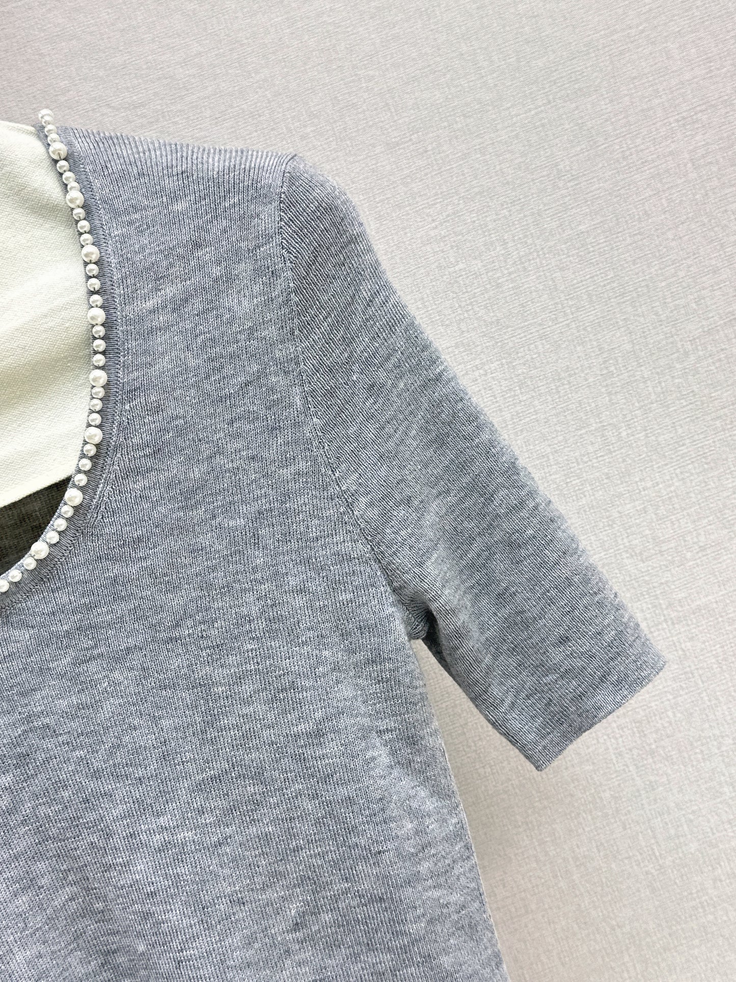 Pearl embellishments on a short-sleeved top