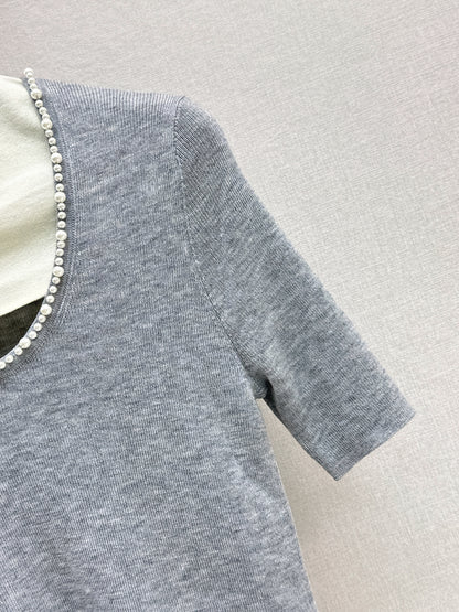 Pearl embellishments on a short-sleeved top