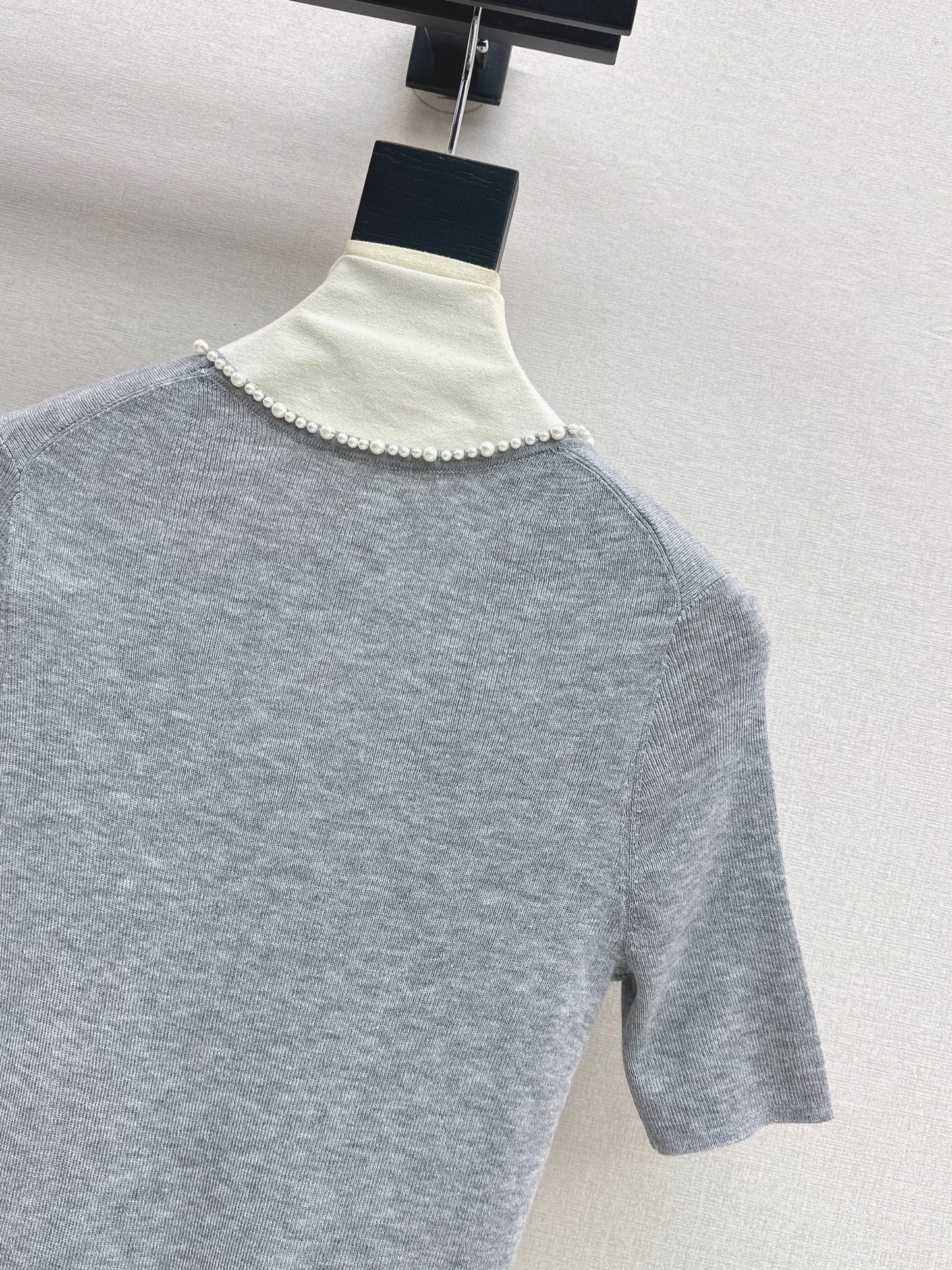 Pearl embellishments on a short-sleeved top