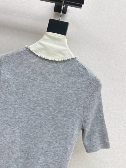 Pearl embellishments on a short-sleeved top