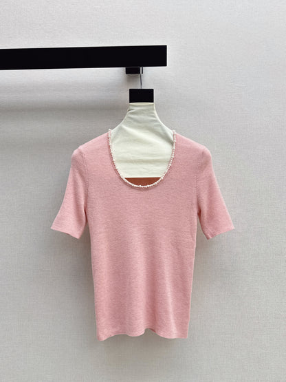 Pearl embellishments on a short-sleeved top