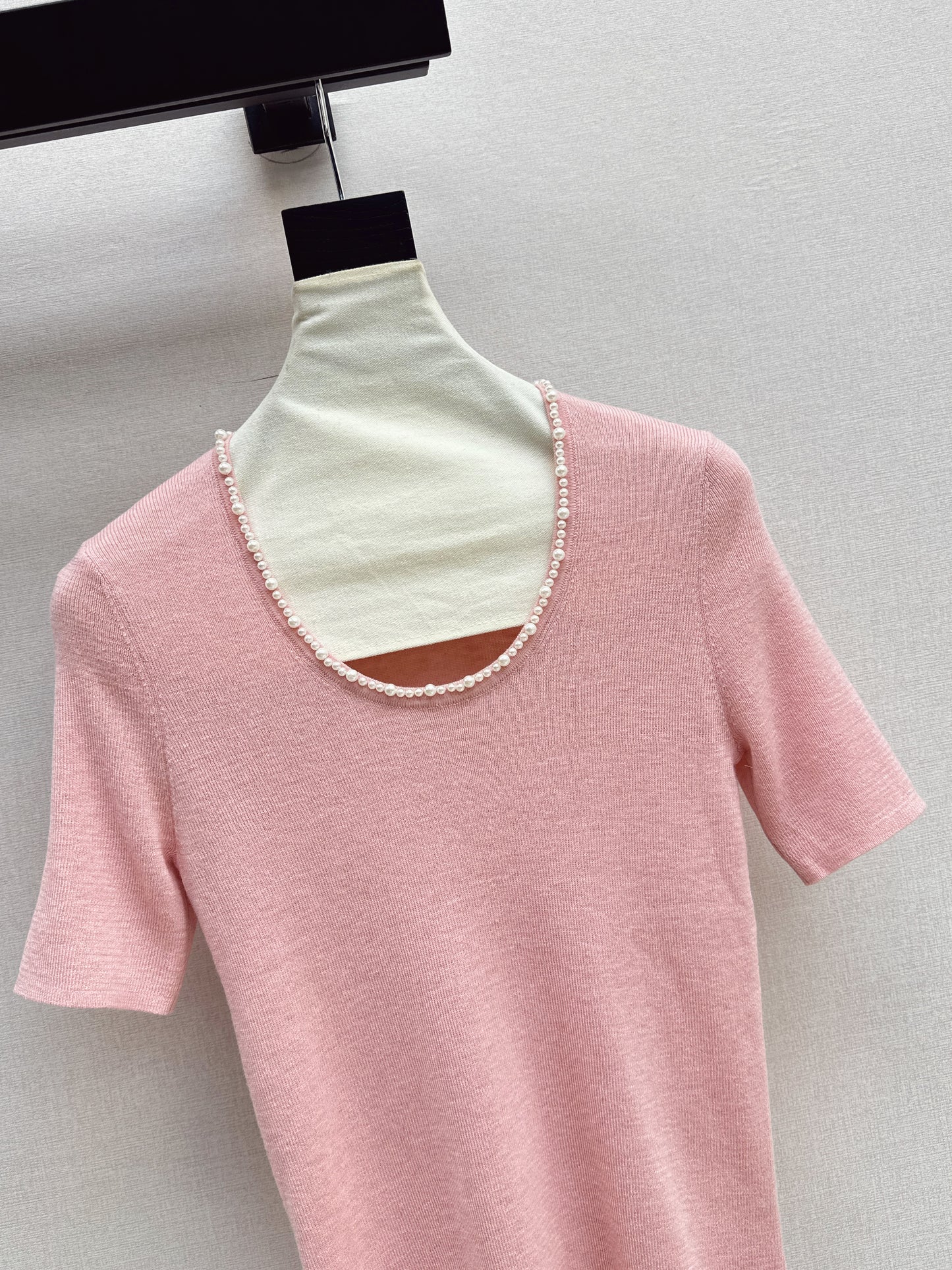 Pearl embellishments on a short-sleeved top