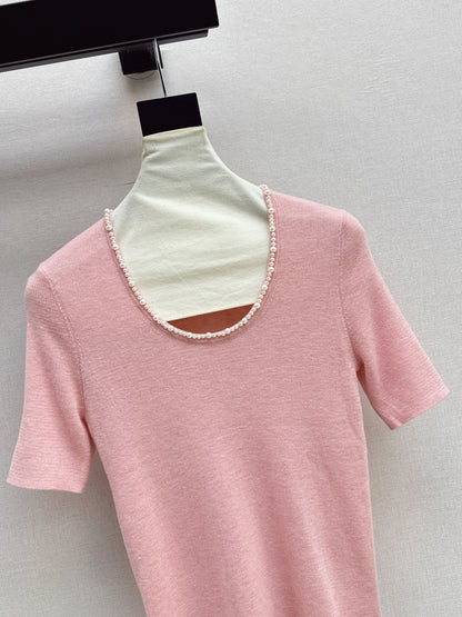 Pearl embellishments on a short-sleeved top