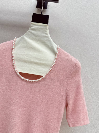Pearl embellishments on a short-sleeved top