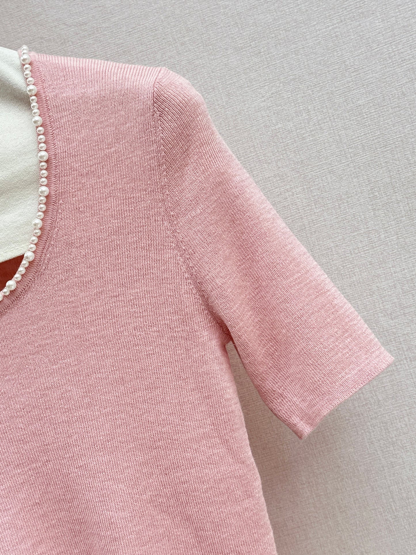 Pearl embellishments on a short-sleeved top