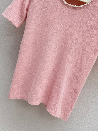 Pearl embellishments on a short-sleeved top