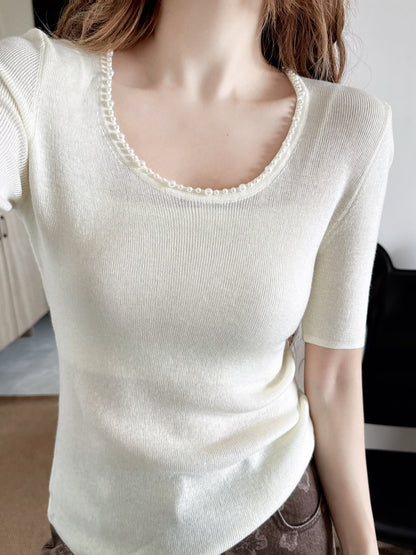 Pearl embellishments on a short-sleeved top