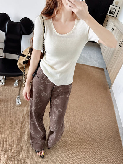 Pearl embellishments on a short-sleeved top