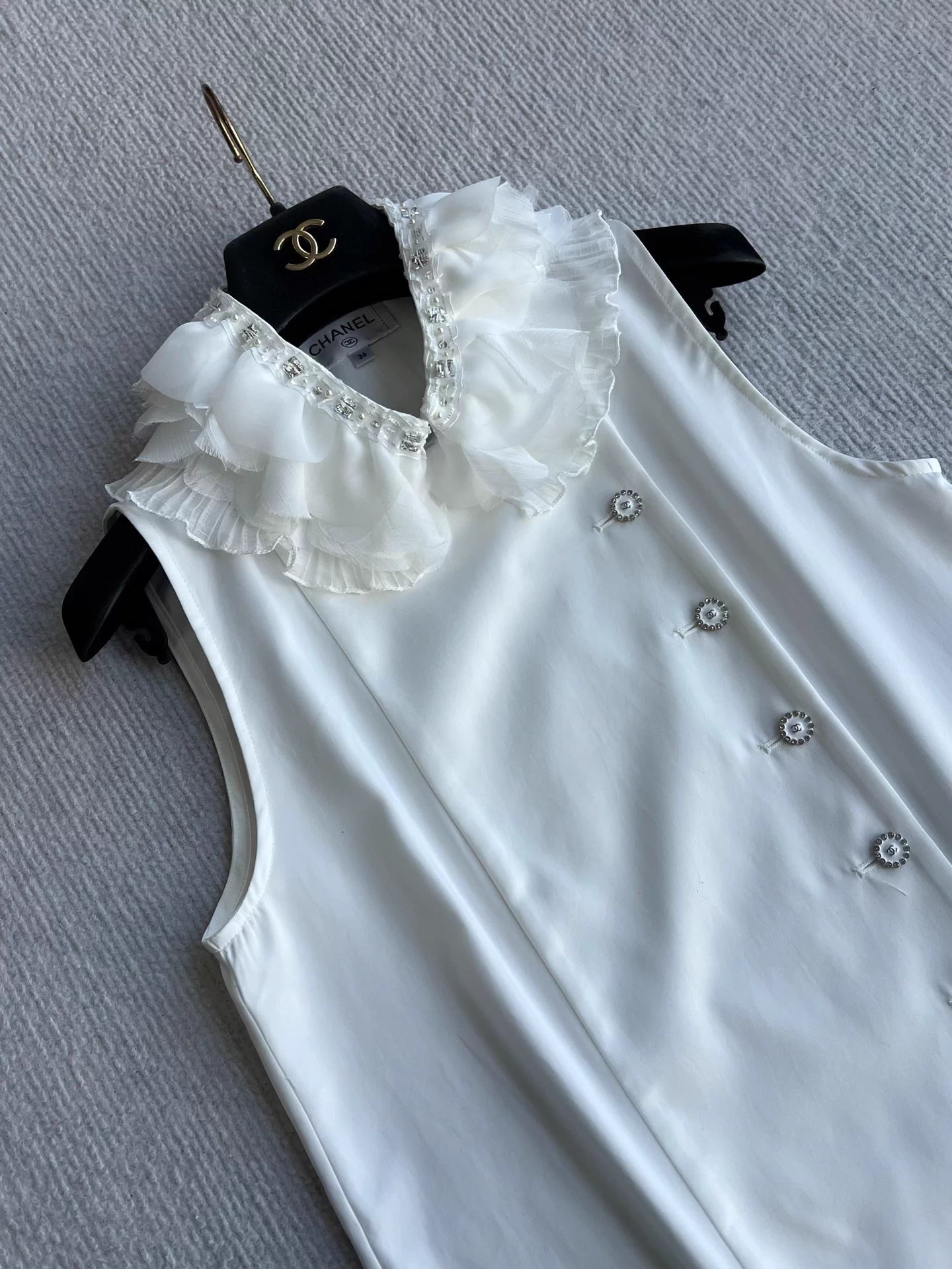 Sleeveless side-button petal blouse