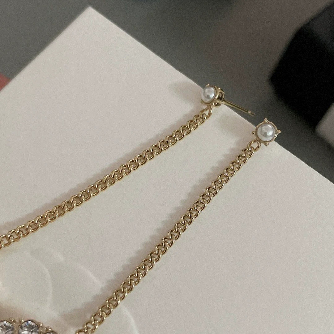 Long chain hanging double C-ear studs