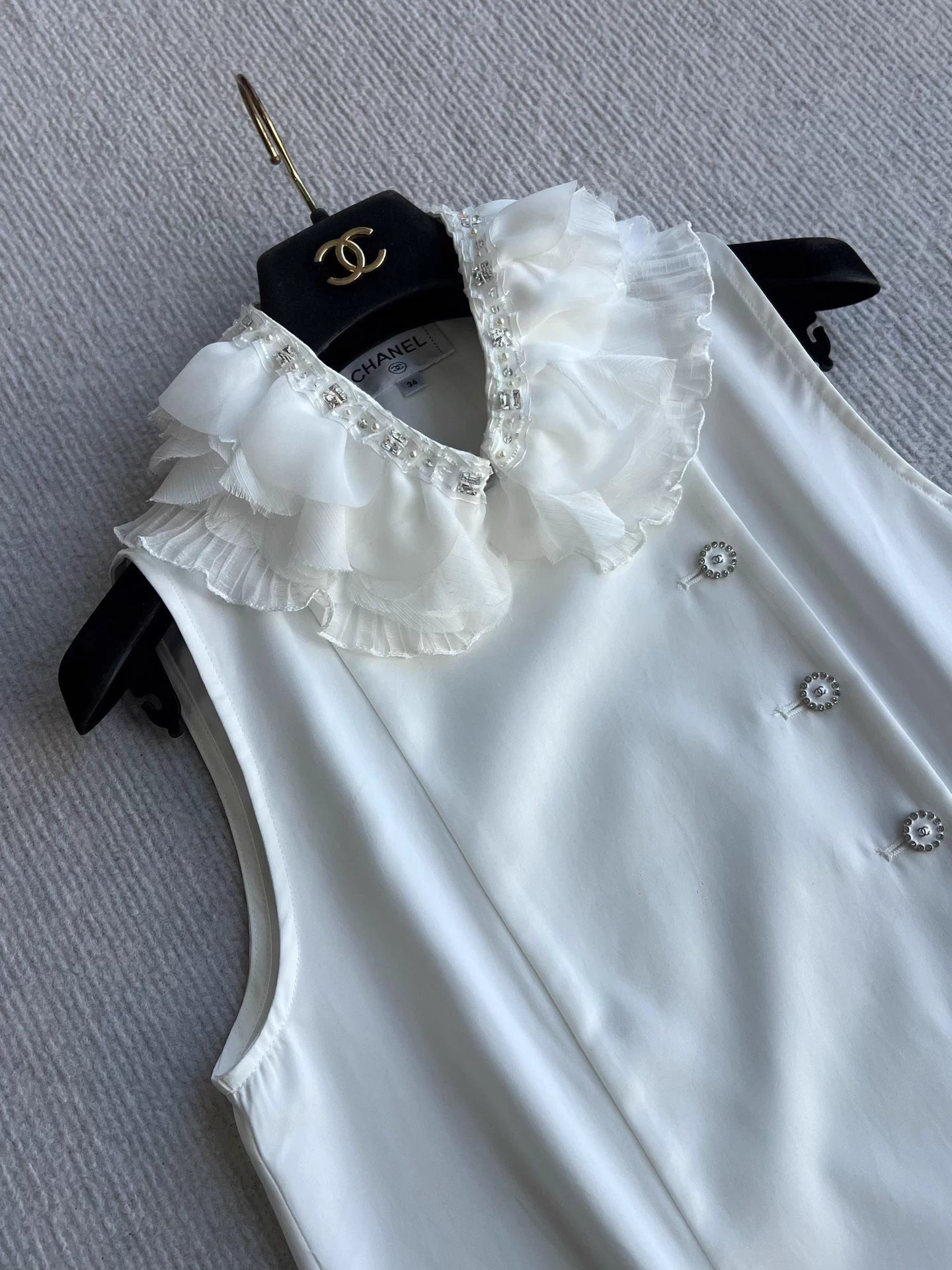 Sleeveless side-button petal blouse