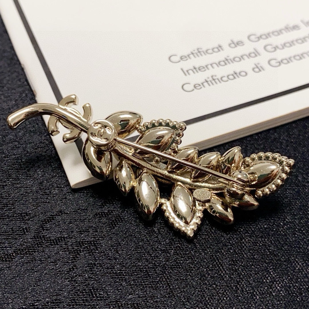 logo brooch