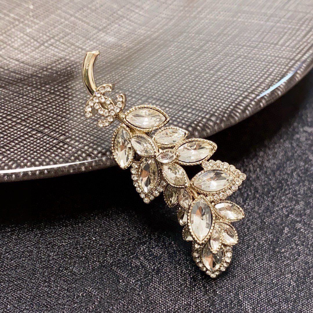 logo brooch